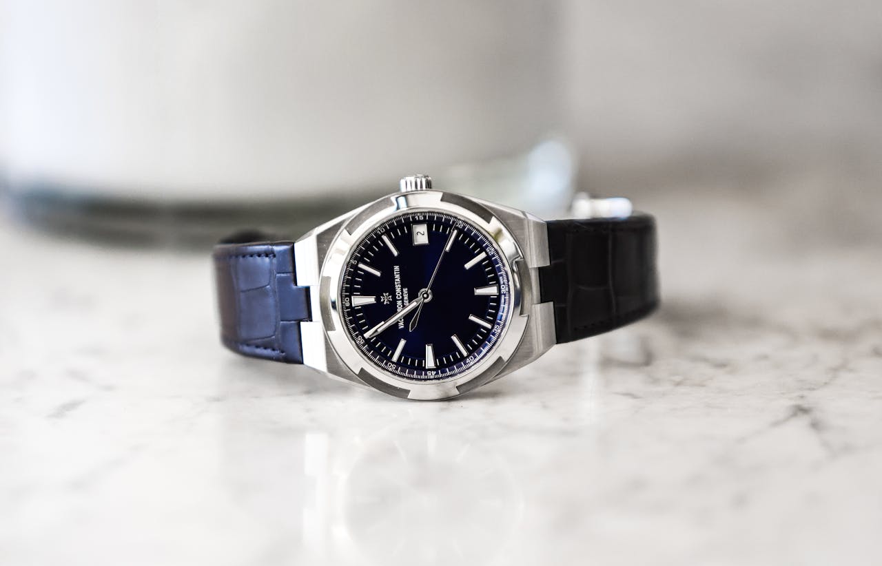 hero-img-01 Sophisticated luxury wristwatch with leather strap displayed on a marble surface, showcasing elegance and precision.